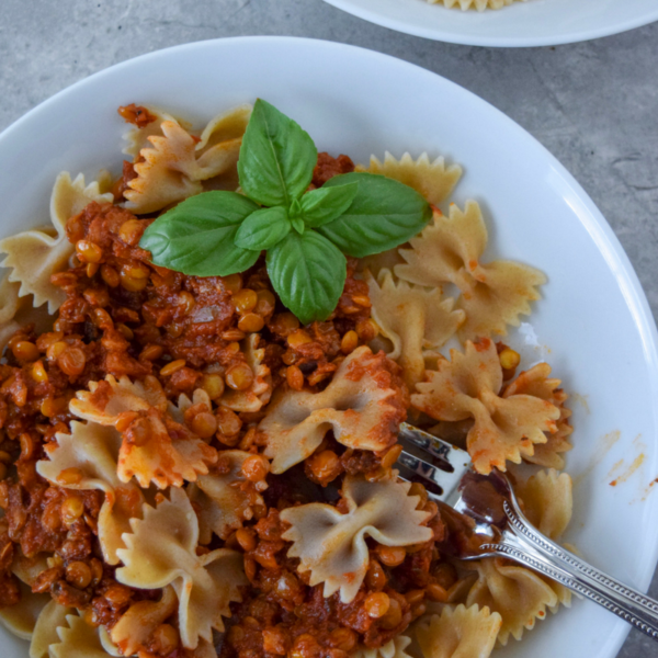 This One-Skillet Spicy Lentil Bolognese is perfect for a #meatlessmonday or vegetarian meal! Protein-packed lentils sub in for ground beef in this cozy pasta dish. Use your favorite jarred pasta sauce and any pasta you have on hand for this quick weeknight meal!